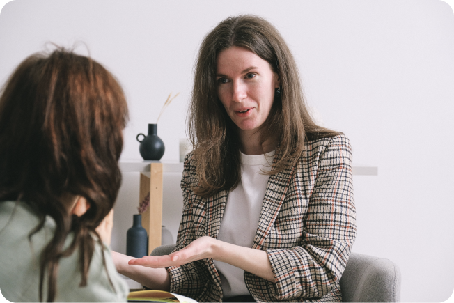 Woman talking to another woman in the process of planning a funeral